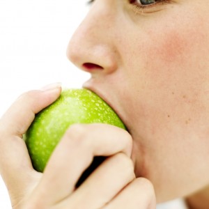 Teen Girl (15-17) Biting into a Green Apple